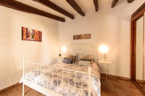 a bedroom with a white bed in a room at Macarena's House in Valldemossa