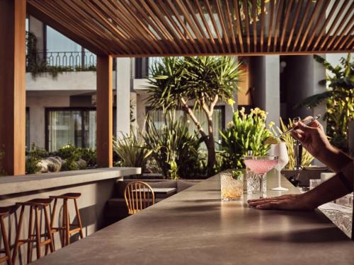 a person sitting at a table with a glass of wine at Contessina Suites & Spa - Adults Only in Tsilivi