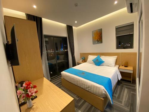 a hotel room with a bed and a television at Euro Star Riverside Hotel in Da Nang