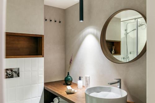 a bathroom with a sink and a mirror at Z17 Apartments in Saint Petersburg