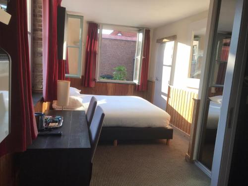 Postel nebo postele na pokoji v ubytování Hotel Koffieboontje