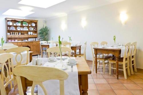 a dining room with tables and chairs in a restaurant at Buchholz Downtown Hotel in Cologne