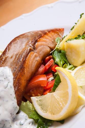 a plate of food with a piece of fish and vegetables at Pension U Přístavu in Pomezí nad Ohří