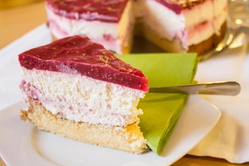 a piece of cake on a plate with a fork at Pension U Přístavu in Pomezí nad Ohří