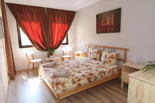 a bedroom with a bed and a table and chairs at Bendida Apartments in Velingrad