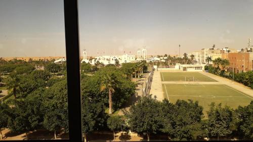 a view of a tennis court from a window at Résidence London in Laayoune