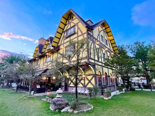 a large building with a tree in front of it at Puli Story House in Puli