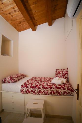 a bedroom with a bed with a red and white blanket at Modica Castle in Modica