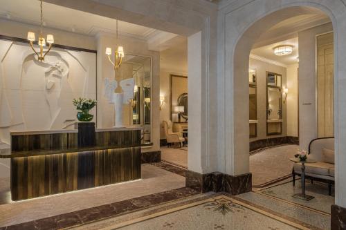 a lobby with a reception desk in a building at Hôtel Elysia by Inwood Hotels in Paris