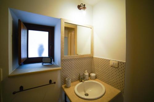 a bathroom with a sink and a mirror at Modica Castle in Modica