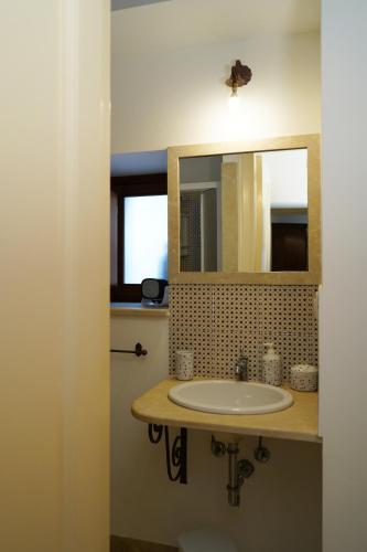 a bathroom with a sink and a mirror at Modica Castle in Modica