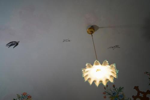 a chandelier hanging from a ceiling in a room at Modica Castle in Modica