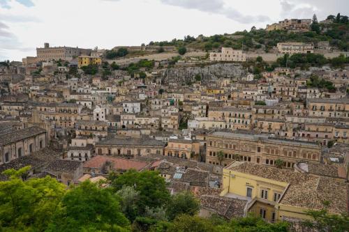 an aerial view of a city with buildings at Modica Castle in Modica