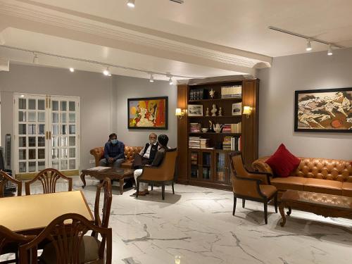 two people sitting in a waiting room at Hotel Jukaso Inn Down Town in New Delhi