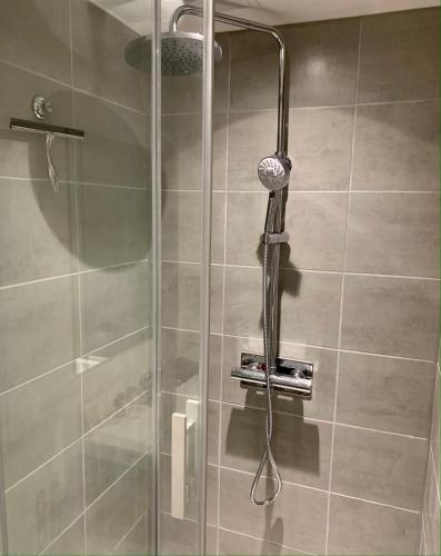 a shower with a shower head in a bathroom at Studio centre ville -001 in Rouen