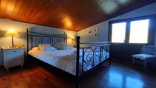 a bedroom with a large bed and a window at Can Castell de Rocabruna in Camprodon