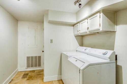 a laundry room with a washer and dryer at Garden Level on Charlton in Savannah