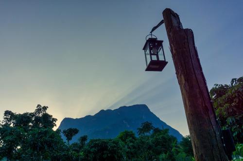 a telephone pole with a mountain in the background at Cozycomo Chiang Dao - Wiang Mek in Chiang Dao
