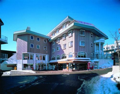 a large building on the side of a street at Resort Inn Marion Shinano in Otari