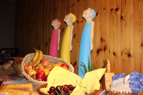 a table with three statues of people holding up their hands at Hotel Urirotstock in Isenthal