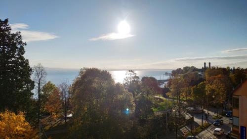 a view of a city with trees and the ocean at Apartment "SUN" in Friedrichshafen