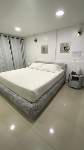 a bedroom with a large bed in a room at Le Castel Blanc Hotel Boutique in San Andrés