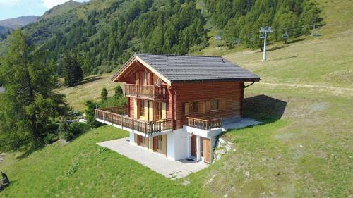 a small house on top of a hill at Narnia SKI IN & SKI OUT chalet 14 pers in Les Collons