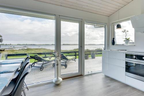 a kitchen with a view of the ocean at Eksklusiv feriebolig med panoramaudsigt in Munkebo