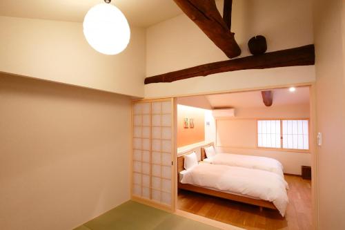 a bedroom with a bed and a large mirror at 肖舎 Shoya in Nara
