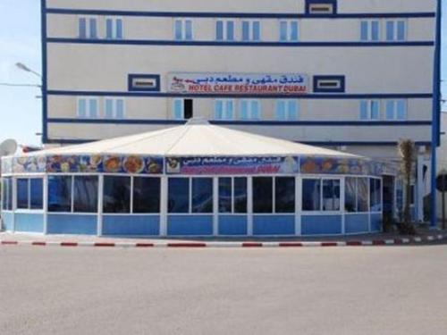 a food stand with a tent in front of a building at Hotel Dubai in Tan-Tan Plage