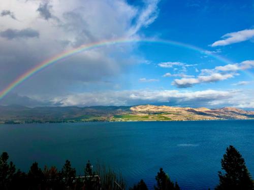 a rainbow over a large body of water at Lakeside Lodge and Suites in Chelan