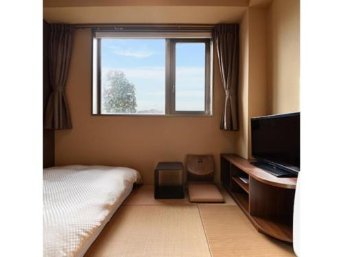 1 dormitorio con 1 cama, TV y ventana en HOTEL FUTABATEI - Vacation STAY 03249v, en Kido