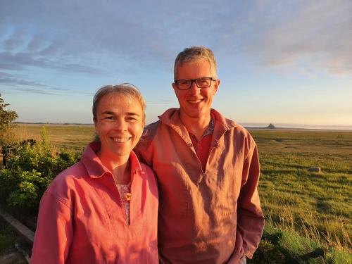 a man and a woman standing in a field at Graine de Reves in Saint-Sauveur-la-Pommeraye