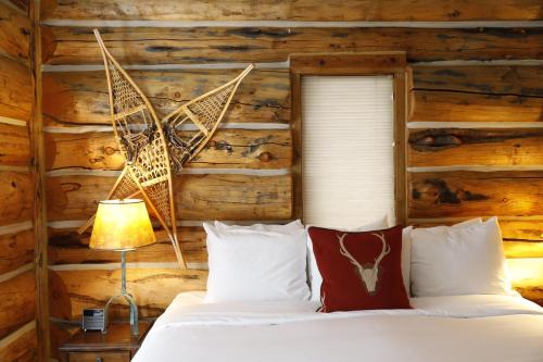 a bedroom with a bed and a wooden wall at Bentwood Inn in Wilson