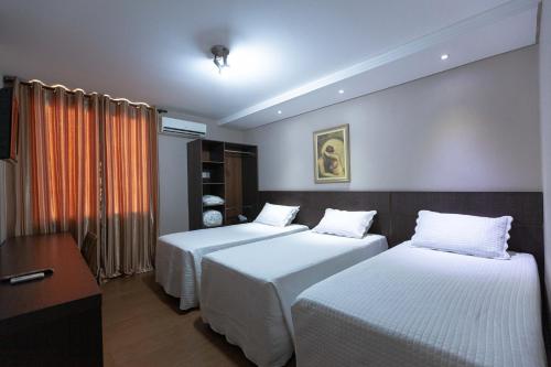 Postel nebo postele na pokoji v ubytování Hotel Foz do Iguaçu