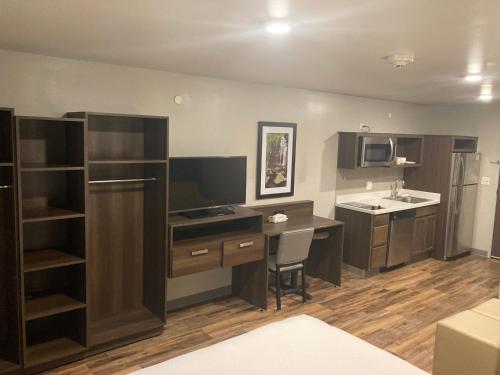 uma pequena cozinha com uma secretária e um lavatório em Woodspring Suites Cherry Hill em Cherry Hill