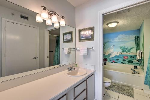 a bathroom with a sink and a large mirror at Oceanfront Retreat with Pool Steps From Ormond Beach in Ormond Beach