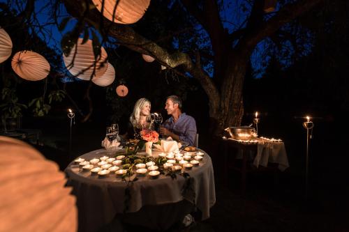 a man and woman sitting at a table at night at Hotel Brücklwirt in Niklasdorf