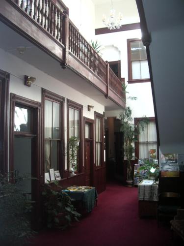 a hallway of a building with a staircase in it at The Monarch Hotel in Port Townsend