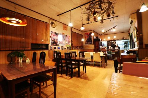 a dining room with tables and chairs in a restaurant at Daigo House in Daigo