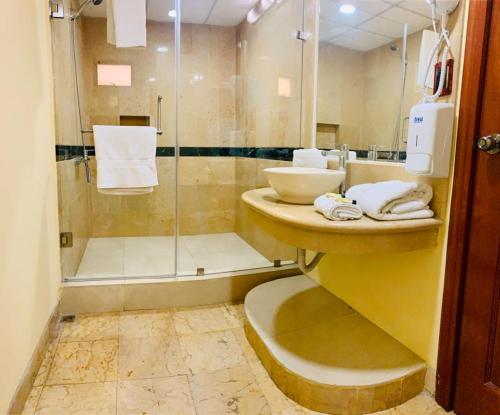 a bathroom with a sink and a shower at Hotel Ruinas Resort in Huehuetenango