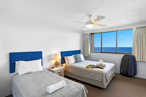 En eller flere senge i et værelse på Breakers North Absolute Beachfront Apartments