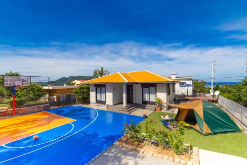 a house with a swimming pool and a basketball hoop at Regina Ishigaki Kabira Sky / Two-Bedroom House in Kabira