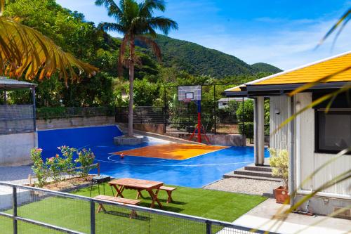 a backyard with a basketball hoop and a pool at Regina Ishigaki Kabira Sky / Two-Bedroom House in Kabira