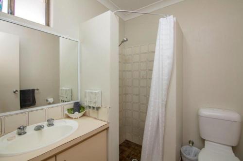 a bathroom with a toilet, sink, and shower at Cervantes Pinnacles Motel in Cervantes