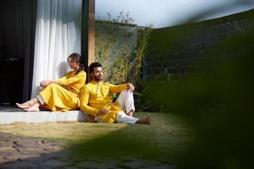a man and woman sitting on a window sill at Viveda Wellness Resort in Nashik