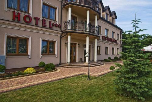 a building with a hotel sign on the side of it at Hotel Hesperus in Międzyrzec Podlaski