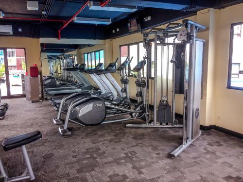 a row of exercise equipment in a gym at Fully Furnished with Comfortable Design 2BR Apartment Atria Residences By Travelio in Tangerang