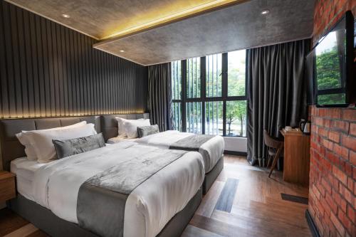 Postel nebo postele na pokoji v ubytování A&R Urban Hotel