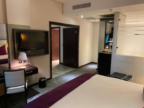 a hotel room with a bed and a flat screen tv at Coastlands Umhlanga Hotel and Convention Centre in Durban